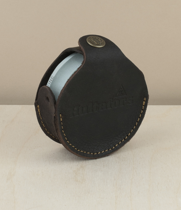 Double sided axe stone with leather case