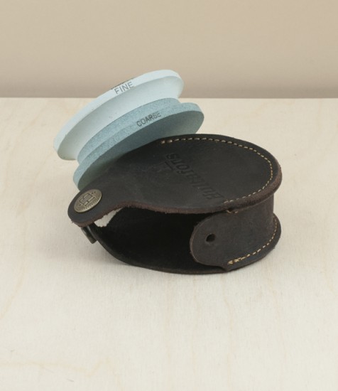 Double sided axe stone with leather case